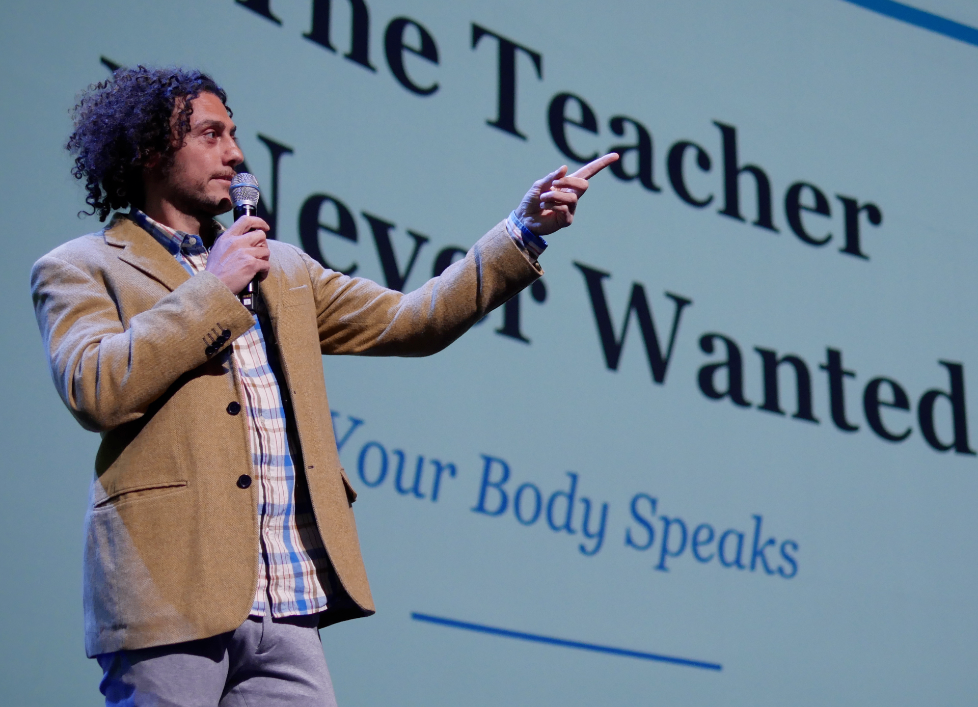 Nima, founder of Get Body Data, speaking on stage about how your body speaks